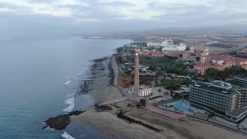 Rotating drone view of the Gran Canaria island Maspalomas in Spain. City view in the evening with li