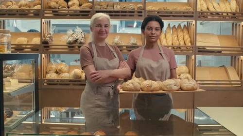 Portrait of Female Colleagues with Freshly Baked Bread in Bakery