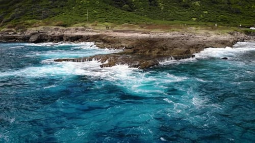 Waves rolling up on a rock flat off the west coast of Hawaii.