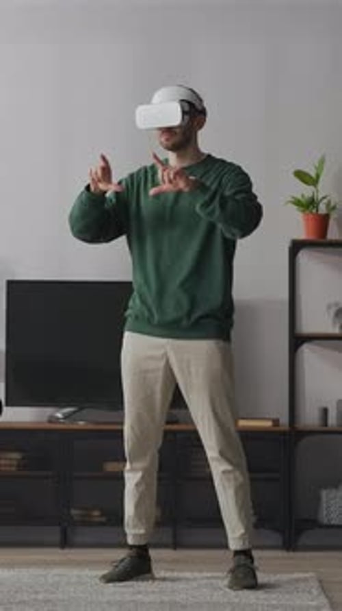 Man Wearing VR Headset Interacting with Virtual Reality