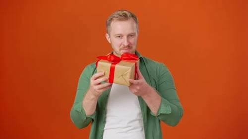 Intriguing Man Receives Gift with Bow Guessing Contents