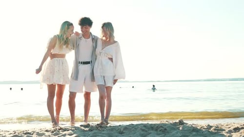Man and two women at seaside