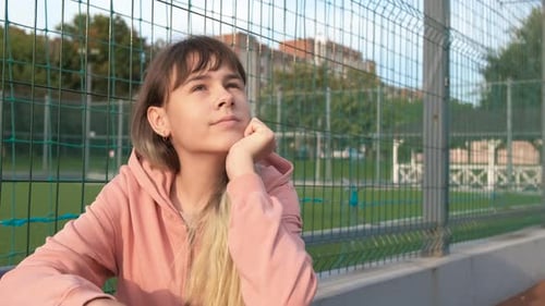 Teenage Girl Thoughtfully Gazing Upwards Outdoors