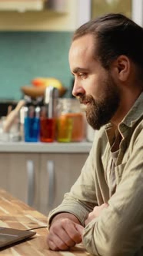 Vertical Video Man Using Laptop for Online Video Content on Streaming Platform