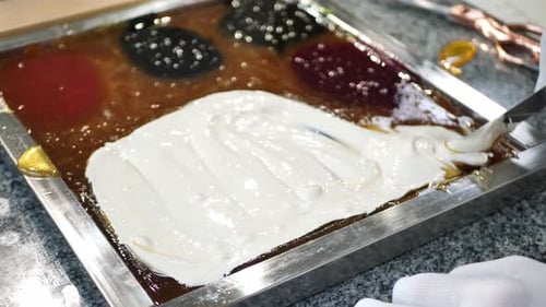 The Chef Adds the Dye to the Hot Caramel Lollipops and Mixes Candy Handmade