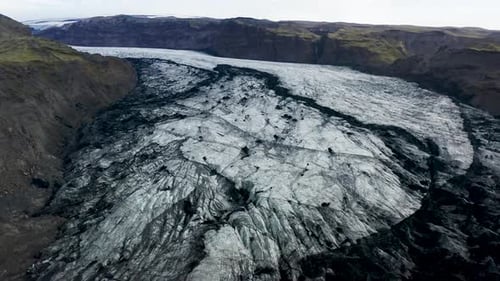 Aerial view of glacier between mountains, Iceland.