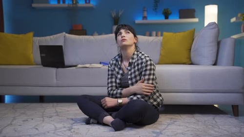 Thoughtful Woman Sitting in Living Room Contemplating