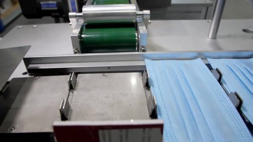 Protective Masks Without Bands Transported By Conveyor