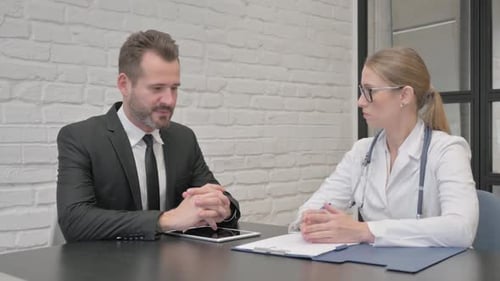 Man Consulting Doctor in Office Setting