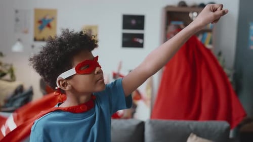 Child and Adult Superheroes Strike a Heroic Pose