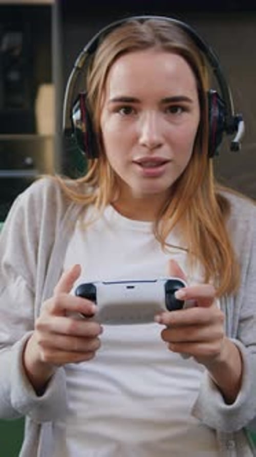 Excited Woman Gamer Playing with Controller and Headset