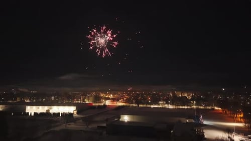 Festive Fireworks Above Distant City Lights at Night