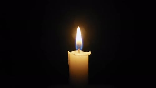 Lighting candle with match in dark close up