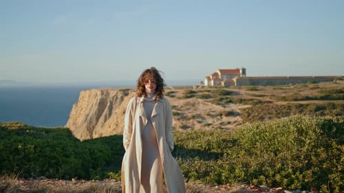 Stylish Girl Walking Ocean Mountain in Morning Sunlight. Romantic Smiling Woman Enjoying