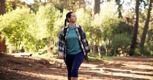 Fitness, walking and woman with hiking in forest for travel adventure, cardio and exploring nature