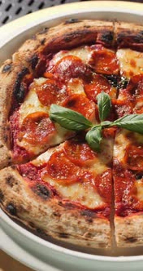 Delicious Pepperoni Pizza with Basil Close Up