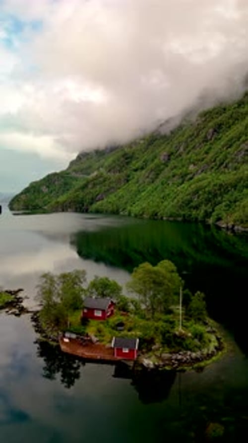 Lovrafjorden Norway Small Island with a Red House in a Lake Surrounded By Mountains