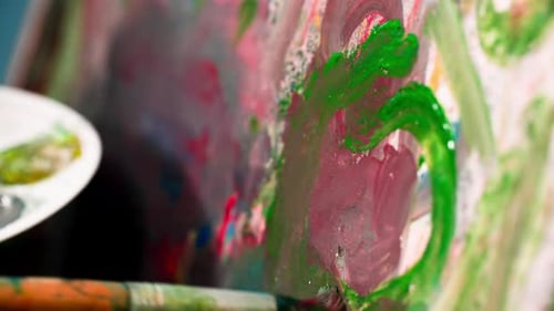 Paint Brush Applying Green Paint on Canvas