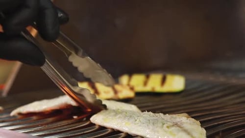 chef cooking fish in the kitchen. Close-up shots