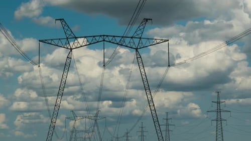 Timelapse of Clouds Moving Over High Voltage Pylons