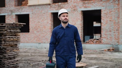 Construction Worker Walking at Building Site