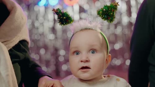 Festive Baby Wearing Christmas Tree Ears Close Up