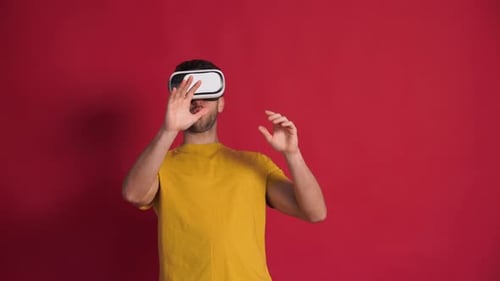 Man Using VR Goggles on Red Background