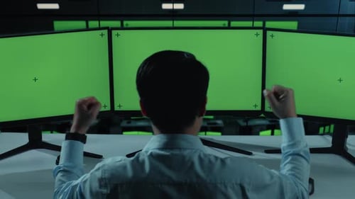 Asian Man Celebrating And Dancing While Working With Mock Up Multiple Computer Monitor In office