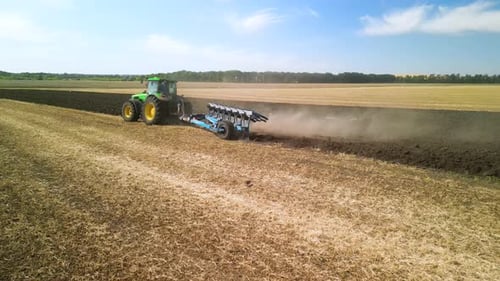 Tractors plowing the field in Ukraine