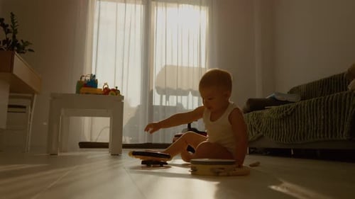 Baby Playing with Toys on Floor in Sunlight