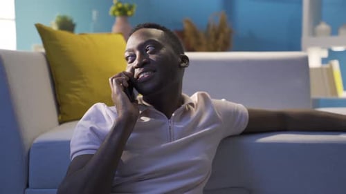 Man Relaxing at Home Talking on Smartphone
