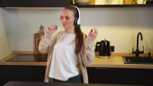 Woman Listening to Music and Dancing at Home