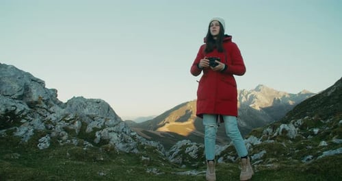 Female Travel Photographer Use Vintage Camera on Mountain Trip at Epic Landscape