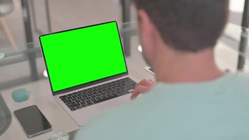 Hombre trabajando en una computadora portátil con pantalla verde Chroma Key