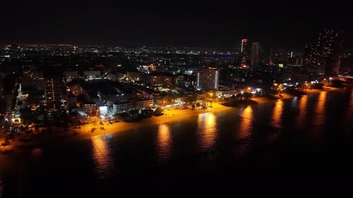 Night Lights Reflecting on the Sea Near the Beach