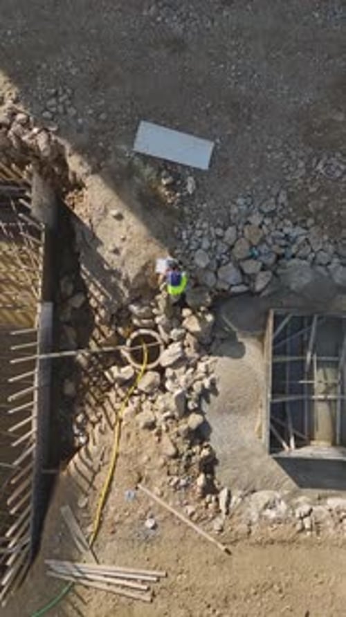 Aerial View of Construction Worker at Urban Construction Site