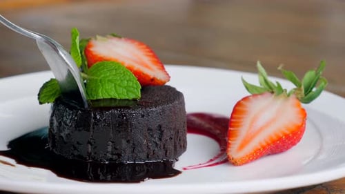 Chocolate Cake Dessert with Strawberries Being Cut