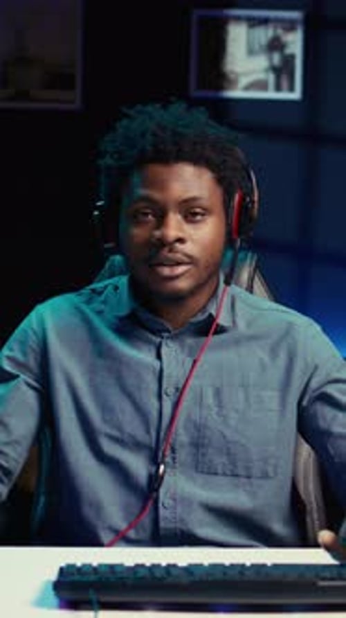 Young Man Speaking Into a Headset With Microphone