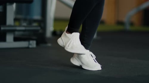 Close Up Shot of Female Feets in Sneakers Jumping at Gym Unrecognizable Woman Athlete Working Out