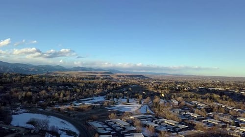 A drone pan over a Denver suburb showing Table Mountain, Golden Colorado.