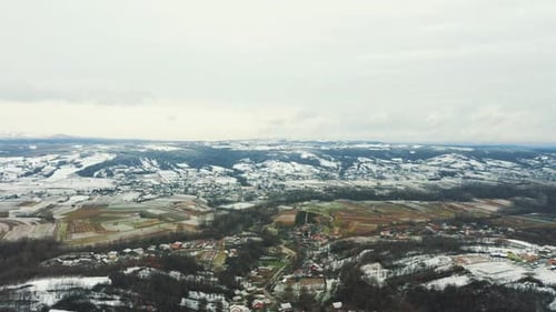 Aerial view of the snowy valley at the foot of the mountain, drone 4K