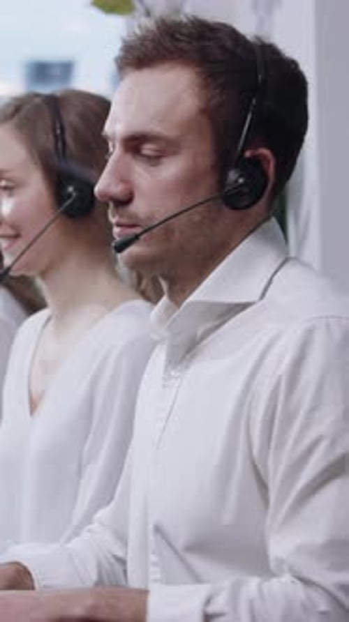 Dedicated and Focused Call Center Agents are Actively Working in a Modern Office Environment
