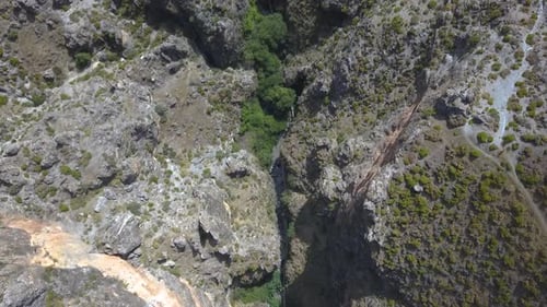 Aerial overhead shot of the course of a river deep in a cliff in a rocky area of the south of Spain.
