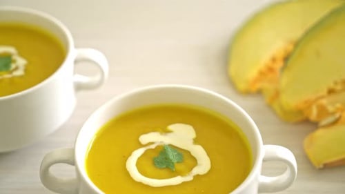 pumpkin soup in white bowl - Vegetarian and vegan food style