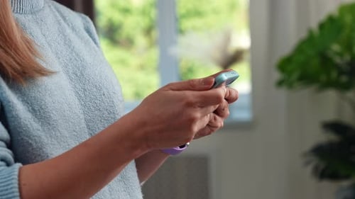 Woman Using a Smart Phone Indoors Daytime