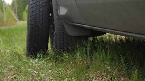 Closeup of Replacing a Damaged Flat Tire in a Car on the Side of the Road