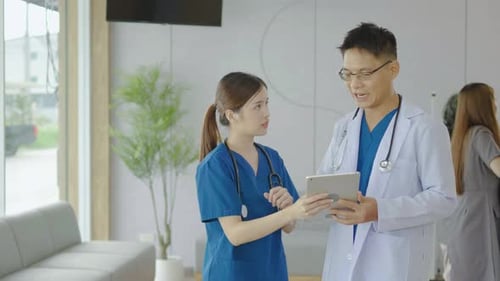 Doctor, nurse and tablet for talking in hospital of strategy for patient diagnosis.