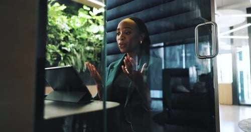 Video call, office and business black woman on laptop in cubicle for private meeting