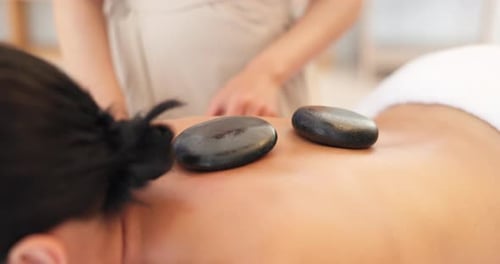 Hands, massage therapist or hot stone in spa, salon or healthcare retreat in self care