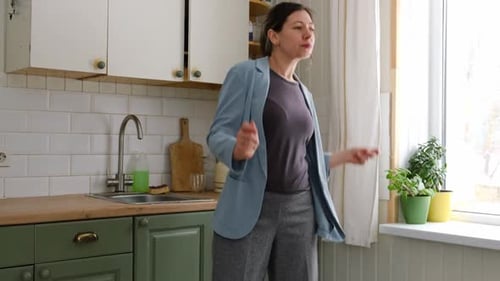 Woman Happily Dancing in Her Kitchen